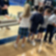 This photograph links to the Saint Nicholas Catholic School Hot Lunch page. It depicts elementary school students in line picking up their lunches.