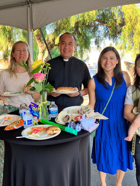 Parents and a priest at the welcome mass that kicks off St. Nich